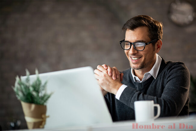 Happy male entrepreneur using laptop while working in the office.
